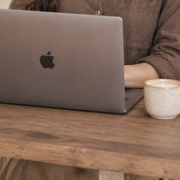 Laptop and coffee on a wooden table