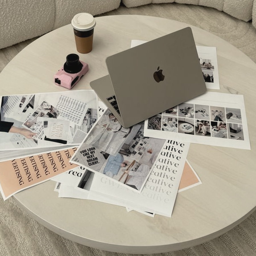 Laptop, printed campaign plans and coffee on a round table