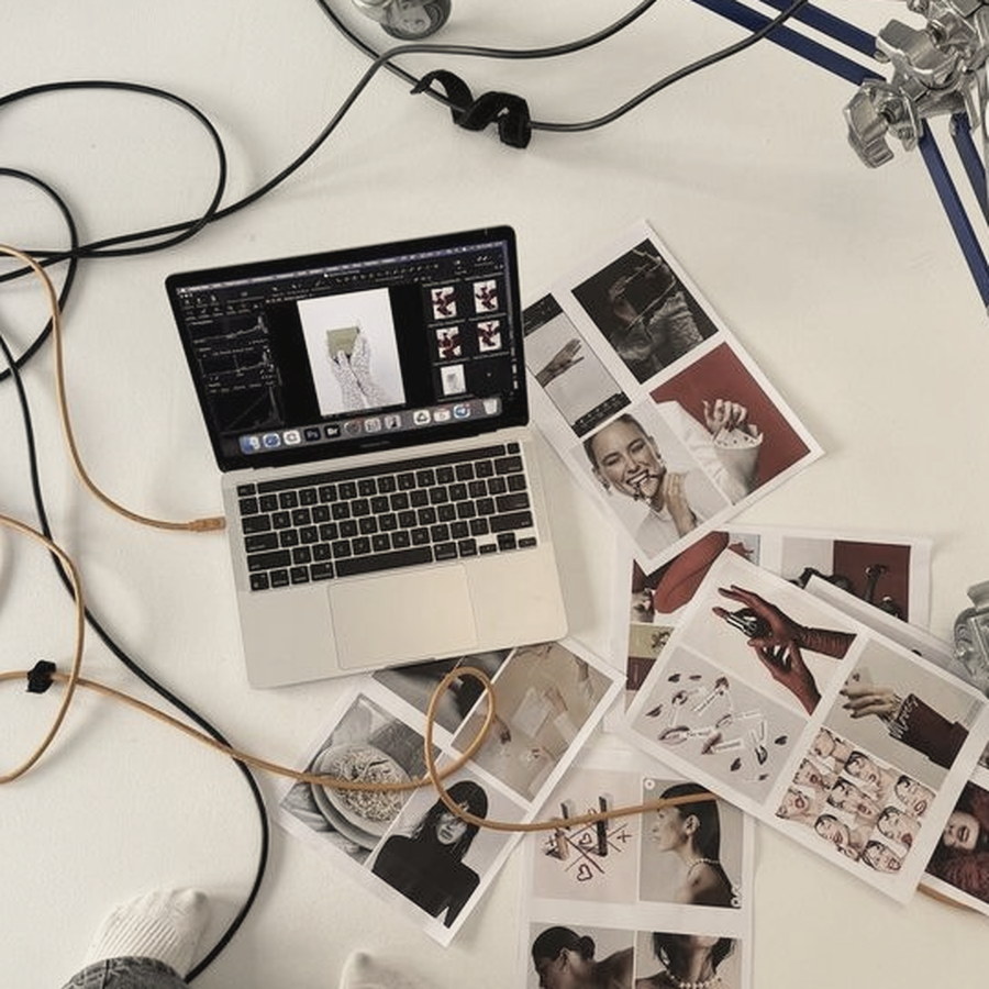 Laptop and printed layouts spread out on the floor